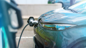 plugged in charger into an electric car at charge station