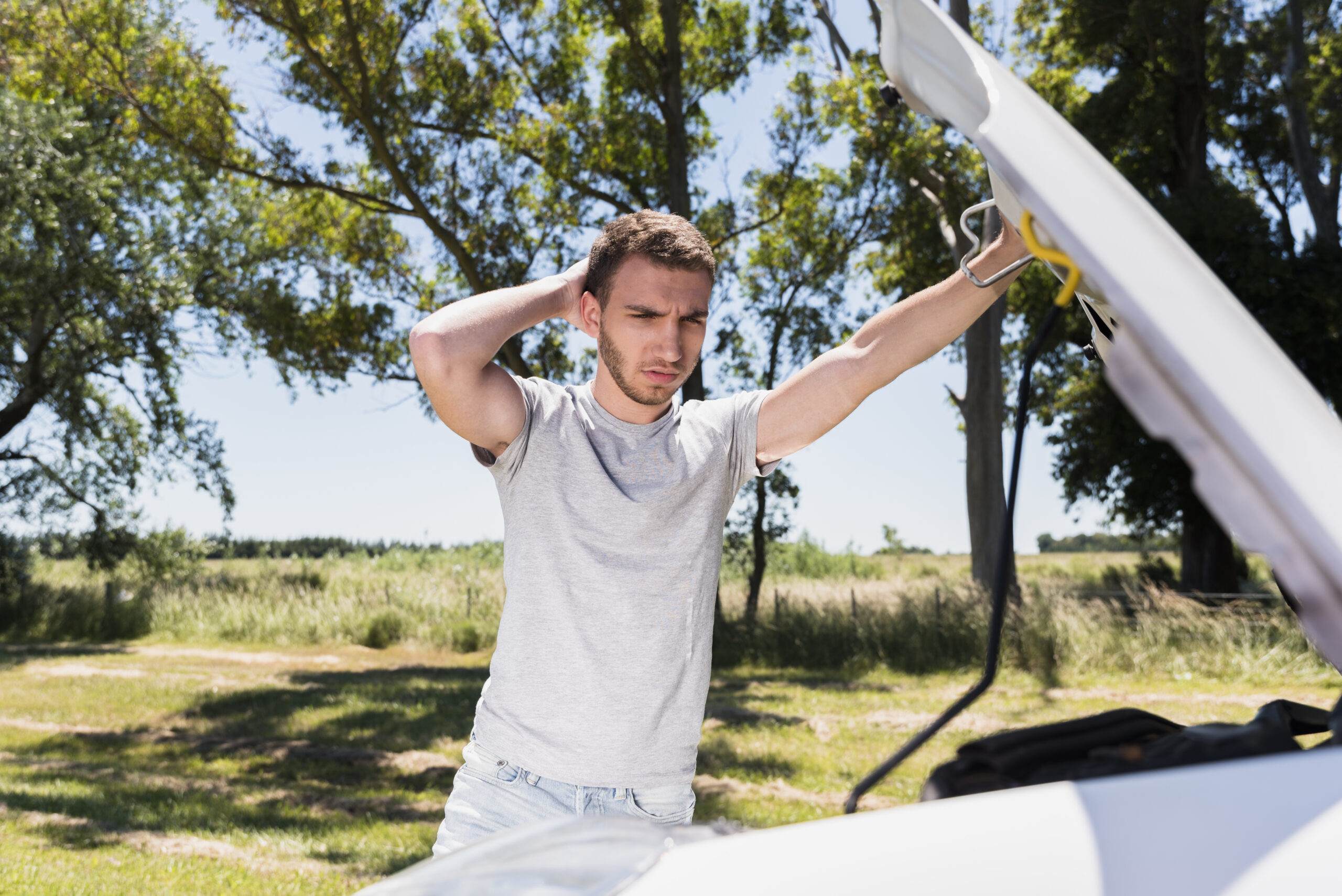 boy looking broken down car scaled